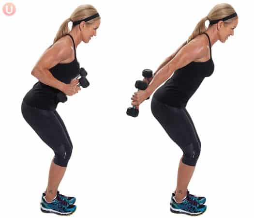 Chris Freytag doing tricep kickbacks standing with black dumbbells. 