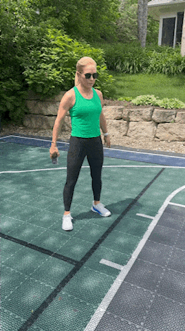 woman demonstrating bodyweight squat