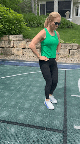 woman demonstrating lunge exercise outdoors