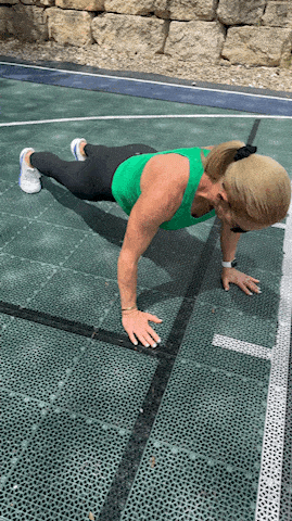 woman doing push up exercise outdoors
