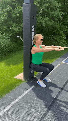 woman showing wall sit exercise